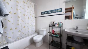 Spacious duplex for renovation in Sol de Mallorca featuring bright interiors, private rooftop terrace, communal pool, large garage, and prime location near beaches, golf courses, international schools, and luxury marinas.