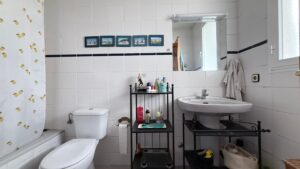 Spacious duplex for renovation in Sol de Mallorca featuring bright interiors, private rooftop terrace, communal pool, large garage, and prime location near beaches, golf courses, international schools, and luxury marinas.